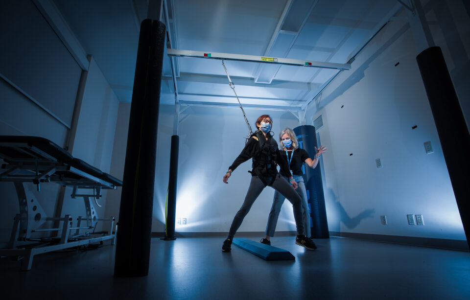 Researcher and participant in a rehabilitation lab